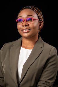 A photo of Tobi Eyinade. She is wearing glasses and is smiling.